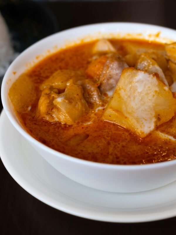 Close-up of a flavorful Japanese curry served with white rice, showcasing vibrant spices.