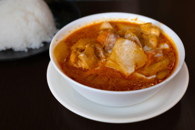 Close-up of a flavorful Japanese curry served with white rice, showcasing vibrant spices.